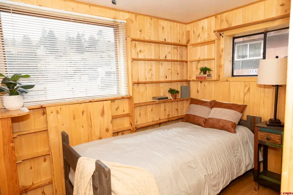 a bedroom with a bed and a window with outer view