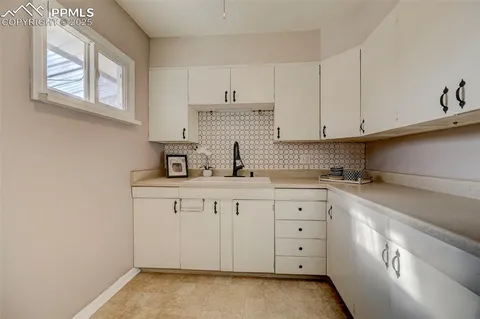 a kitchen with stainless steel appliances a stove a sink and cabinets