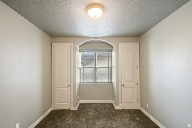 1997 West Cres Drive Mapleton, UT 84664 - Photo 18 of 35 Unfurnished room with dark colored carpet and a textured ceiling