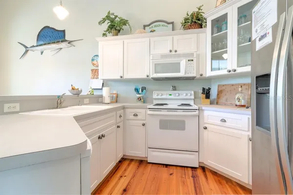 a kitchen with a white cabinets and white appliances