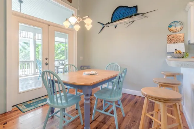 a dining room with furniture a rug and a chandelier