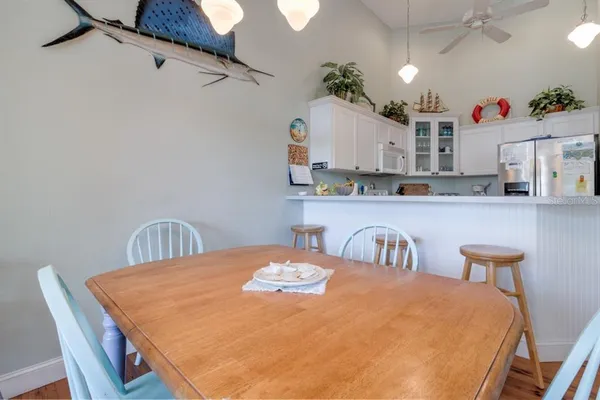 a dining table with kitchen island and wooden floor