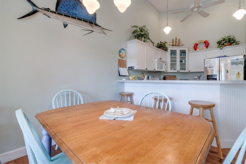 191 Kettle Harbor Drive Boca Grande, FL 33921 - Photo 16 of 50 a dining table with kitchen island and wooden floor