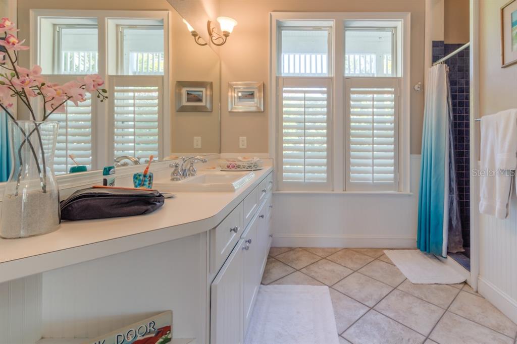 191 Kettle Harbor Drive Boca Grande, FL 33921 - Photo 22 of 50 a bathroom with a sink and a window