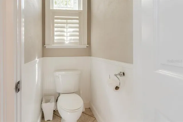 a white toilet sitting next to a window