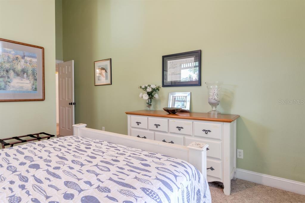 191 Kettle Harbor Drive Boca Grande, FL 33921 - Photo 26 of 50 a bedroom with a bed and a lamp on dresser