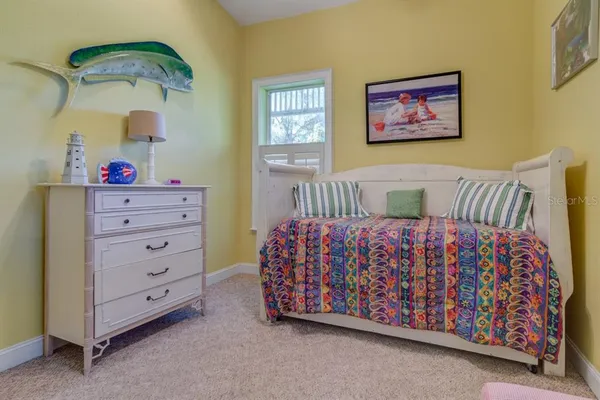 a bedroom with a bed and a dresser