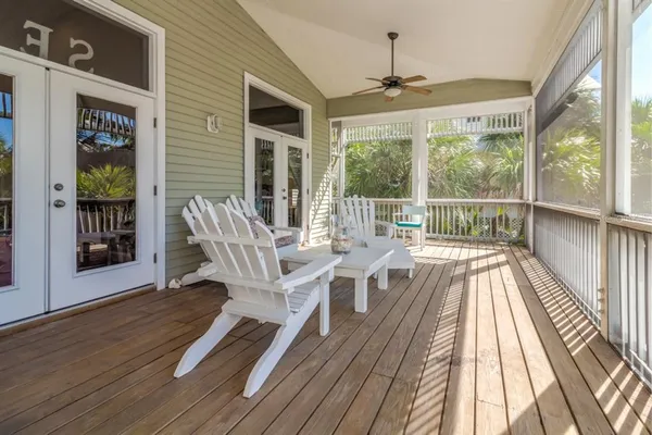 a view of a patio with table and chairs and wooden floor