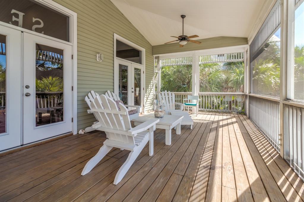 191 Kettle Harbor Drive Boca Grande, FL 33921 - Photo 39 of 50 a view of a patio with table and chairs and wooden floor