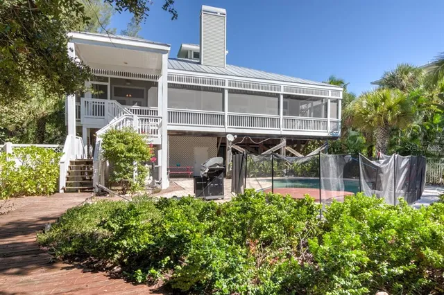 front view of house with a yard and potted plants