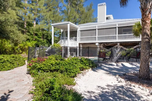 a front view of a house with a yard and balcony