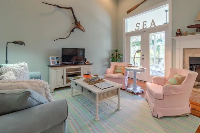 a living room with furniture a rug and a flat screen tv