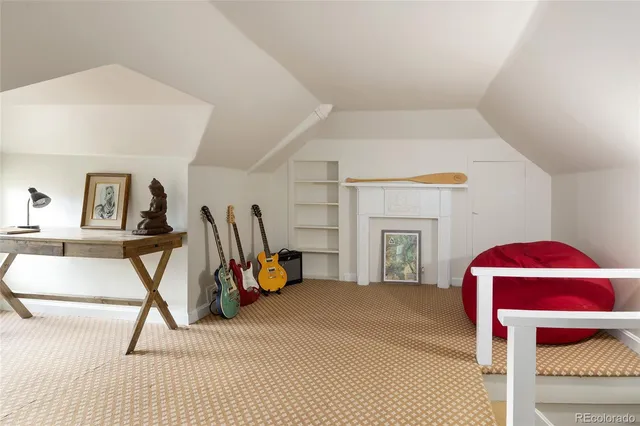 a view of a livingroom with a fireplace and a workspace