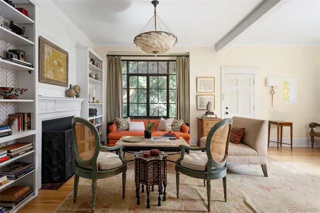 a dining room with furniture a rug and a flat screen tv