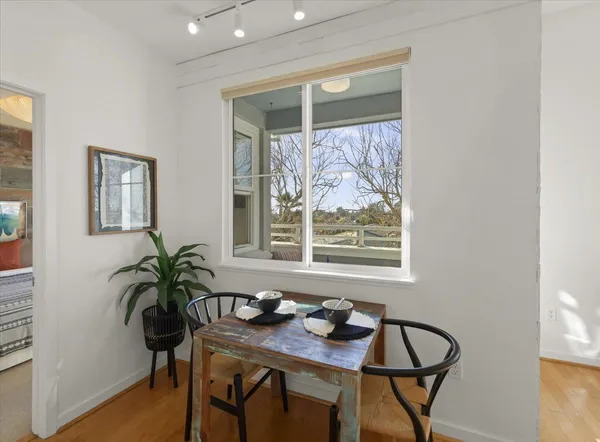 a view of a workspace room with furniture and window