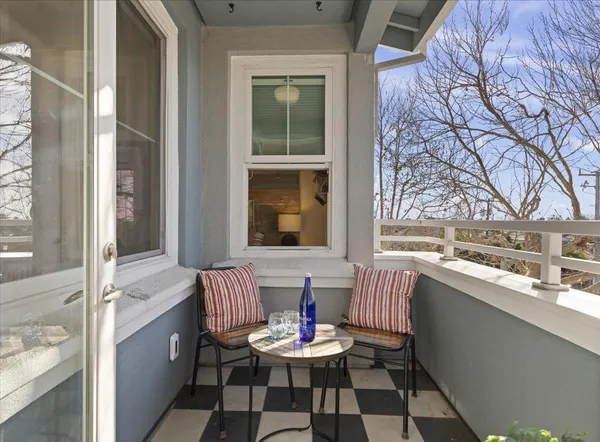 a living room with stainless steel appliances granite countertop furniture and a window
