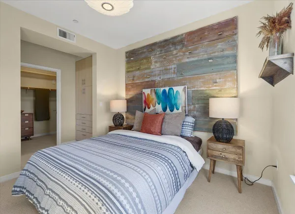 a bedroom with bed and a chandelier