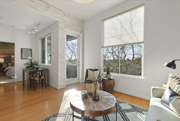 a living room with furniture a table and a large window