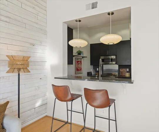 a kitchen with a dining table and chairs