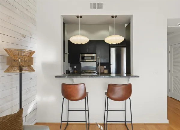 a kitchen with stainless steel appliances granite countertop a sink and a cabinets