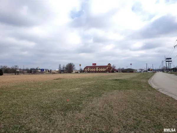 a view of a field with ocean view