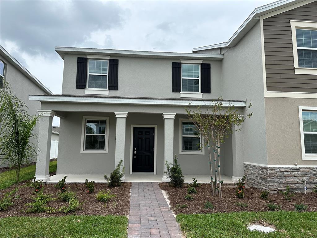 a front view of a house with garden