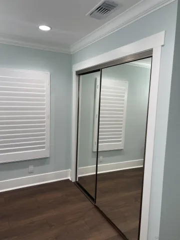 a view of a room with wooden floor and window