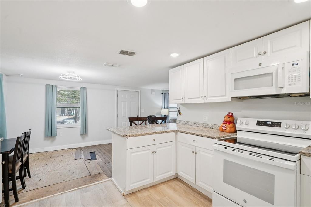 2432 Northwest 2nd Street Ocala, FL 34475 - Photo 13 of 29 a kitchen with a sink cabinets and window