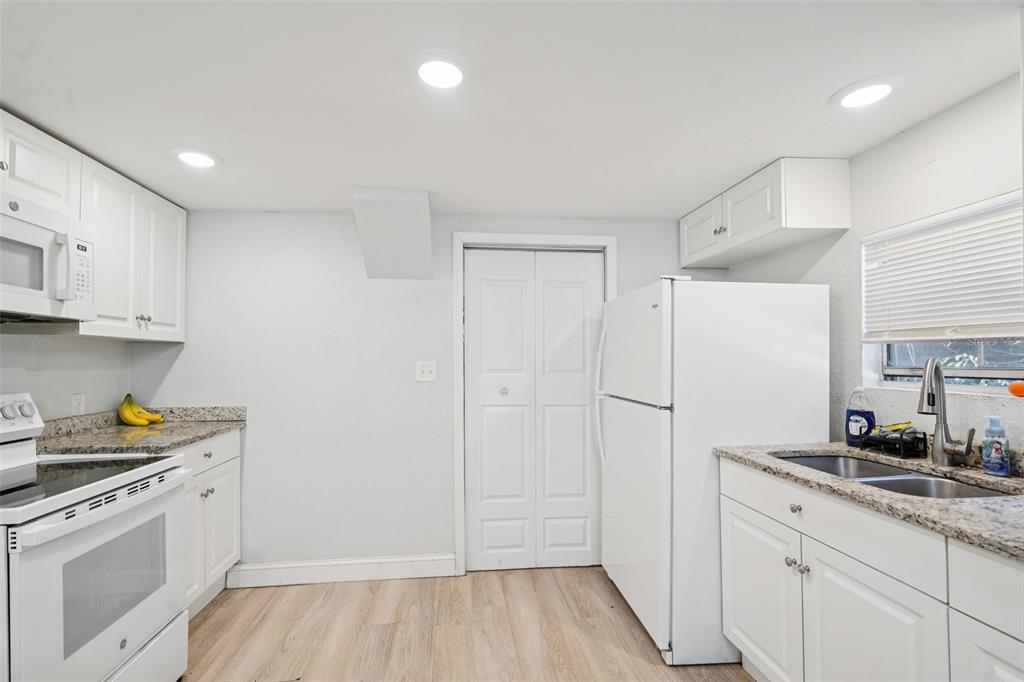 2432 Northwest 2nd Street Ocala, FL 34475 - Photo 15 of 29 a kitchen with a sink a stove a refrigerator and cabinets