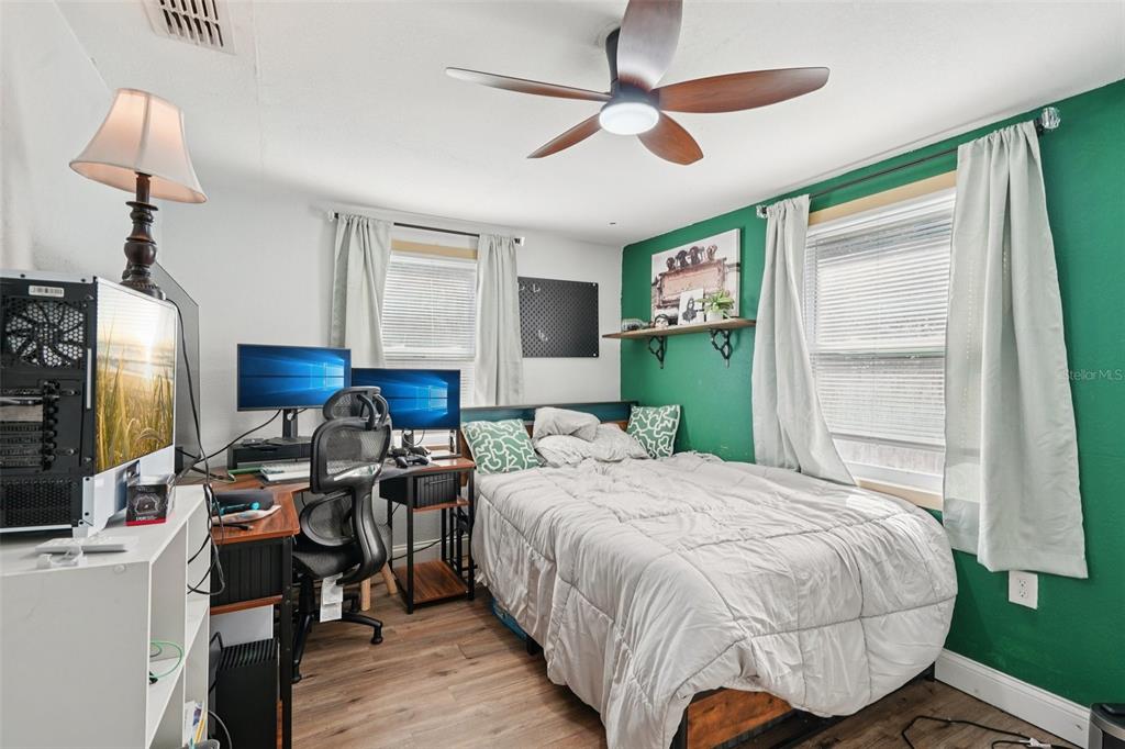 2432 Northwest 2nd Street Ocala, FL 34475 - Photo 19 of 29 a bedroom with a bed and a mirror