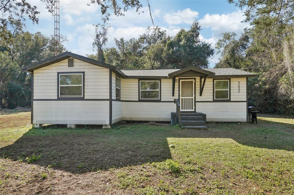 2432 Northwest 2nd Street Ocala, FL 34475 - Photo 2 of 29 a view of a house with a yard