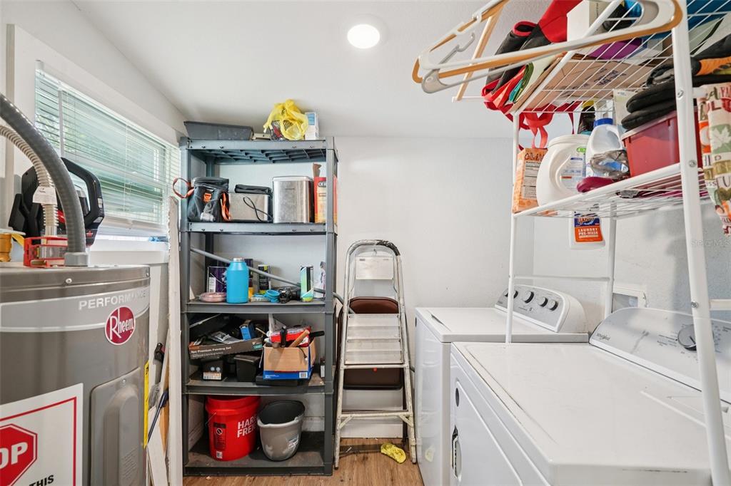 2432 Northwest 2nd Street Ocala, FL 34475 - Photo 22 of 29 a utility room with lots of clutter and cabinets