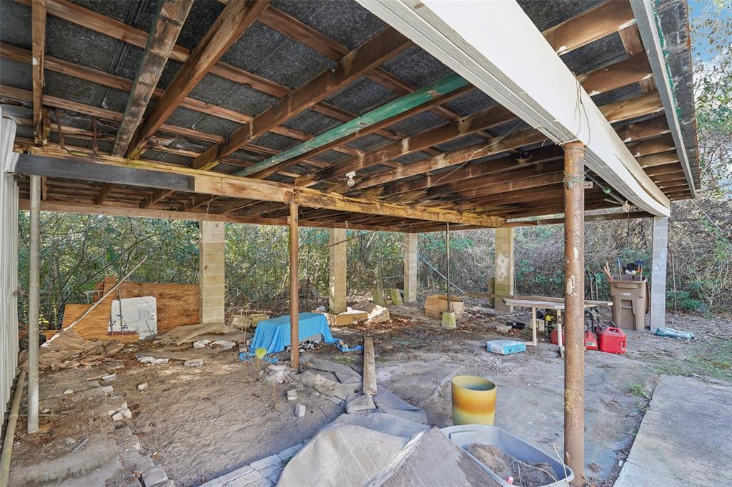 2432 Northwest 2nd Street Ocala, FL 34475 - Photo 27 of 29 a view of a patio with table and chairs potted plants with floor to ceiling window