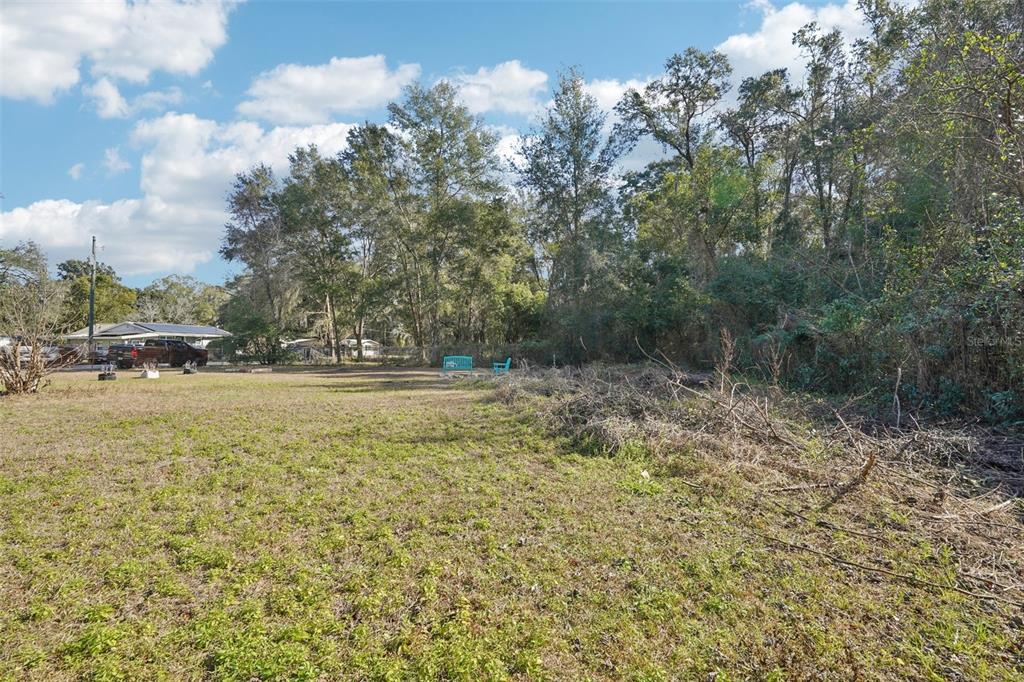 2432 Northwest 2nd Street Ocala, FL 34475 - Photo 29 of 29 a view of outdoor space with swimming pool and trees in the background