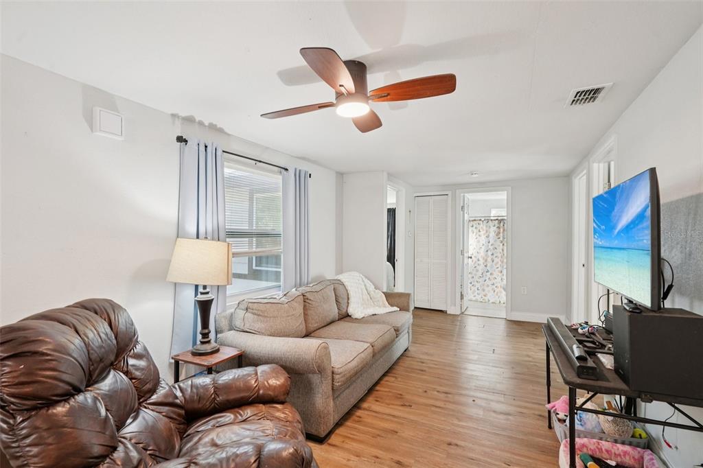 2432 Northwest 2nd Street Ocala, FL 34475 - Photo 5 of 29 a living room with furniture a ceiling fan and a window