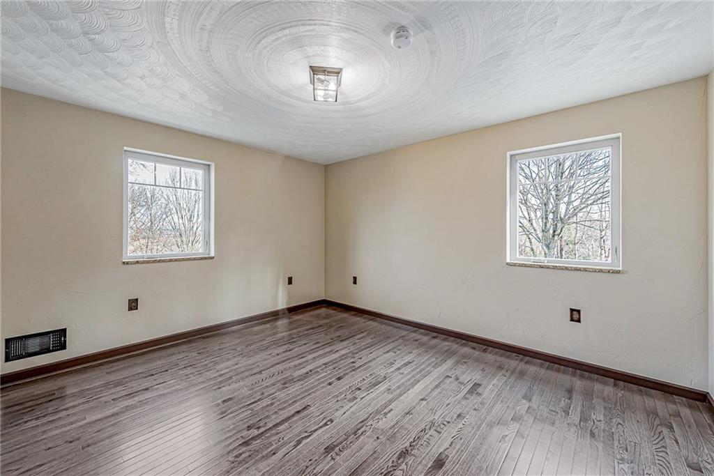 320 Highway 31 Ruffs Dale, PA 15679 - Photo 11 of 19 a view of an empty room with a window and wooden floor