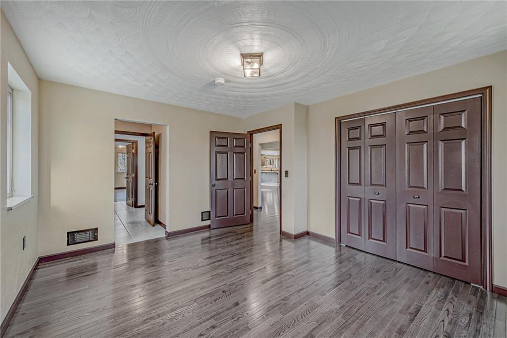 320 Highway 31 Ruffs Dale, PA 15679 - Photo 13 of 19 an empty room with wooden floor and windows