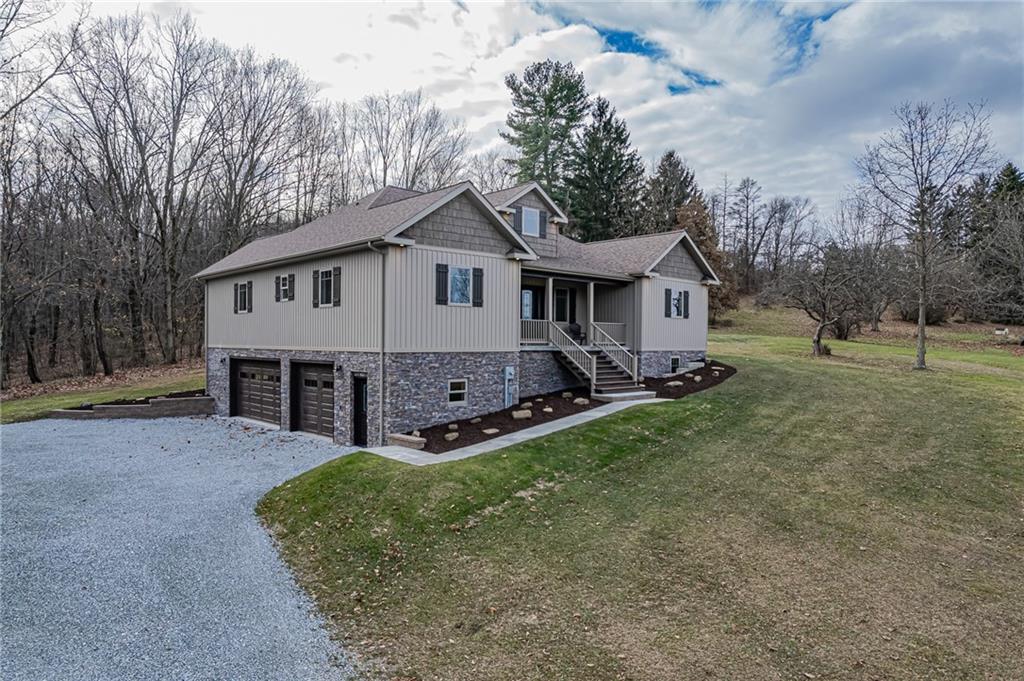 320 Highway 31 Ruffs Dale, PA 15679 - Photo 4 of 19 a front view of house with yard and trees in the background