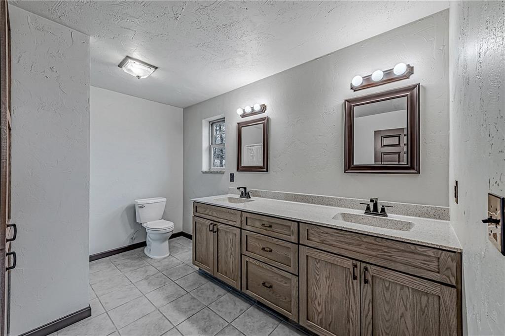 320 Highway 31 Ruffs Dale, PA 15679 - Photo 10 of 19 a bathroom with a toilet sink and mirror