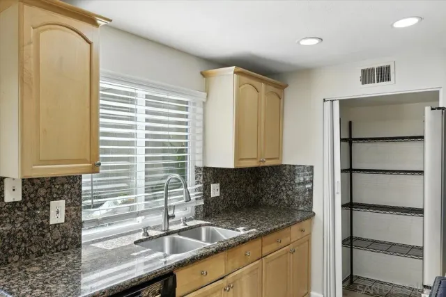 a kitchen with a sink and a refrigerator