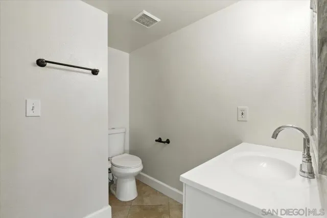 a bathroom with a toilet and a sink