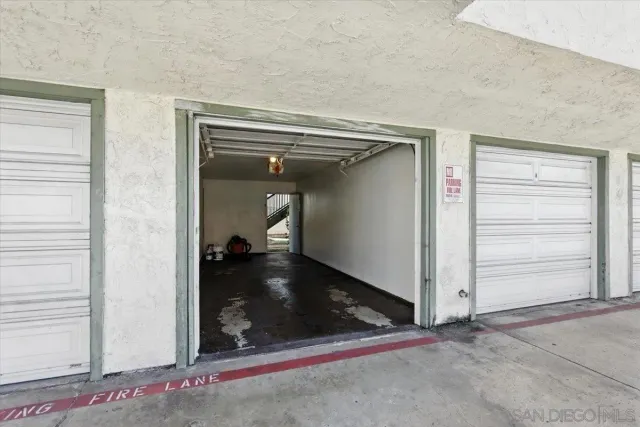 a view of a hallway with wooden floor and closet