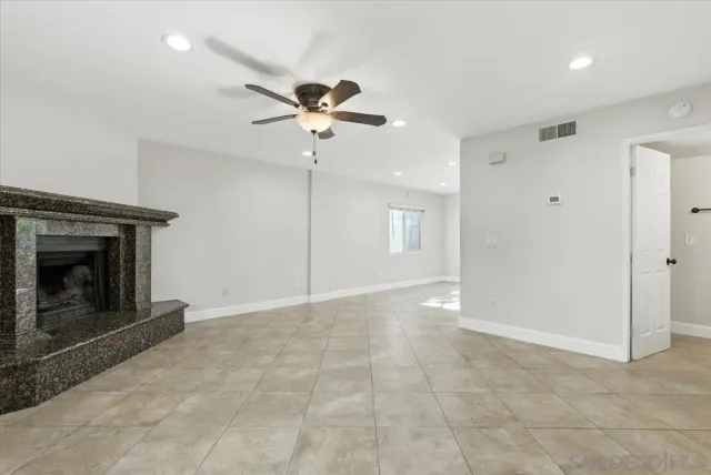 a view of an empty room with a fireplace
