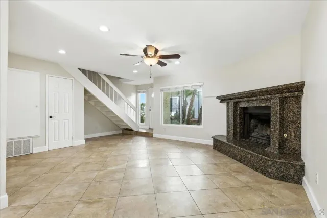 a view of a livingroom with a fireplace and window