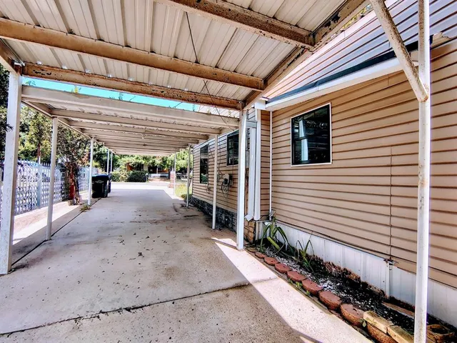 a view of a backyard with wooden fence