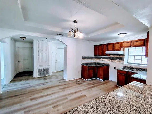 a view of a kitchen with a sink and a fireplace