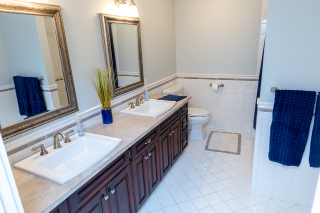 434 Cardon Ridge Drive Smithfield, UT 84335 - Photo 41 of 59 Bathroom with double vanity, wainscoting, tile walls, and light tile patterned floors