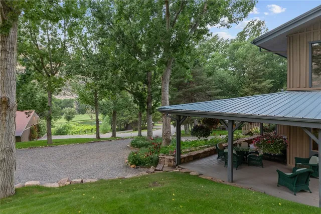 a view of a patio with lawn chairs next to a yard