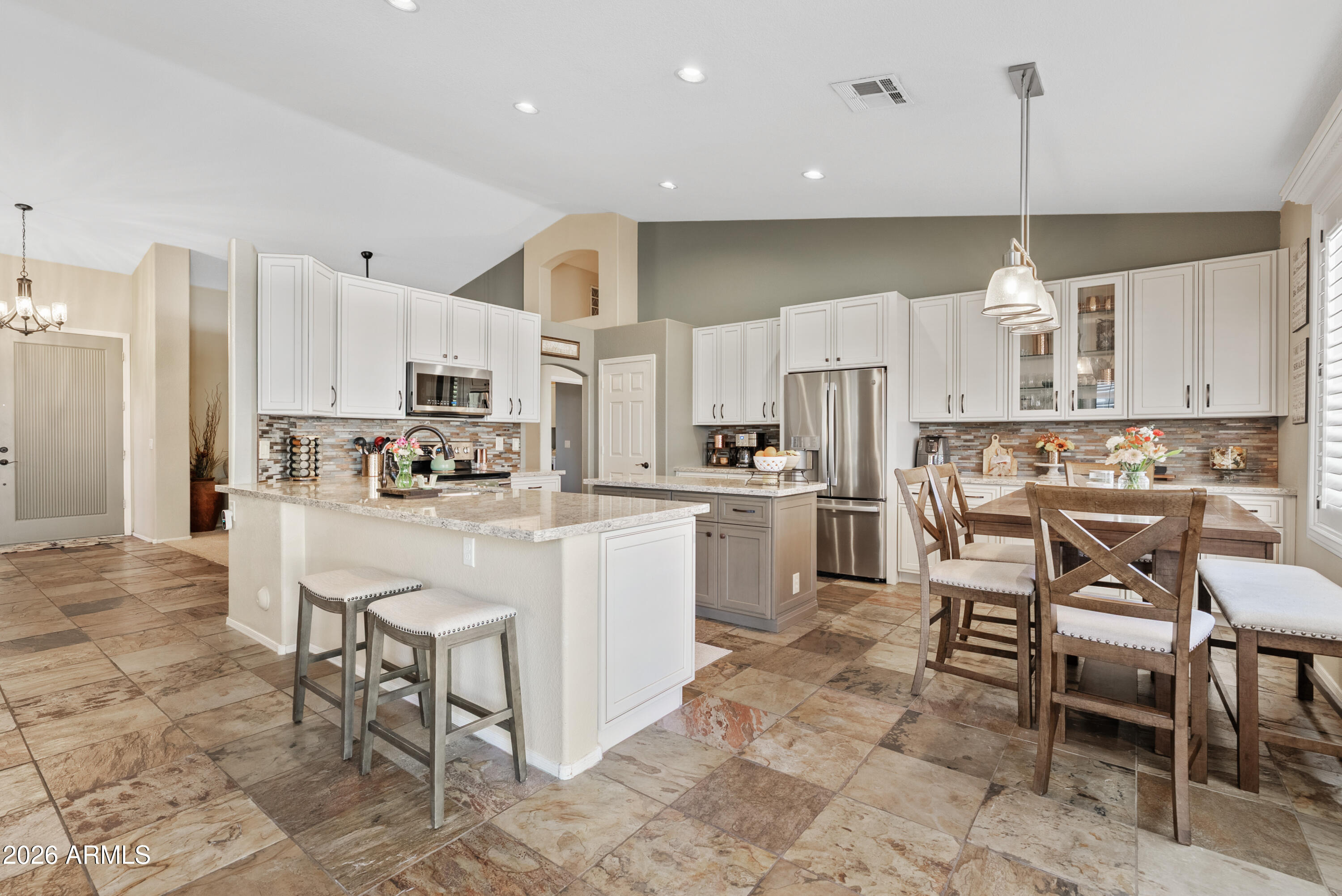 550 South Oak Street Gilbert, AZ 85233 - Photo 16 of 41 a kitchen with kitchen island white cabinets and stainless steel appliances