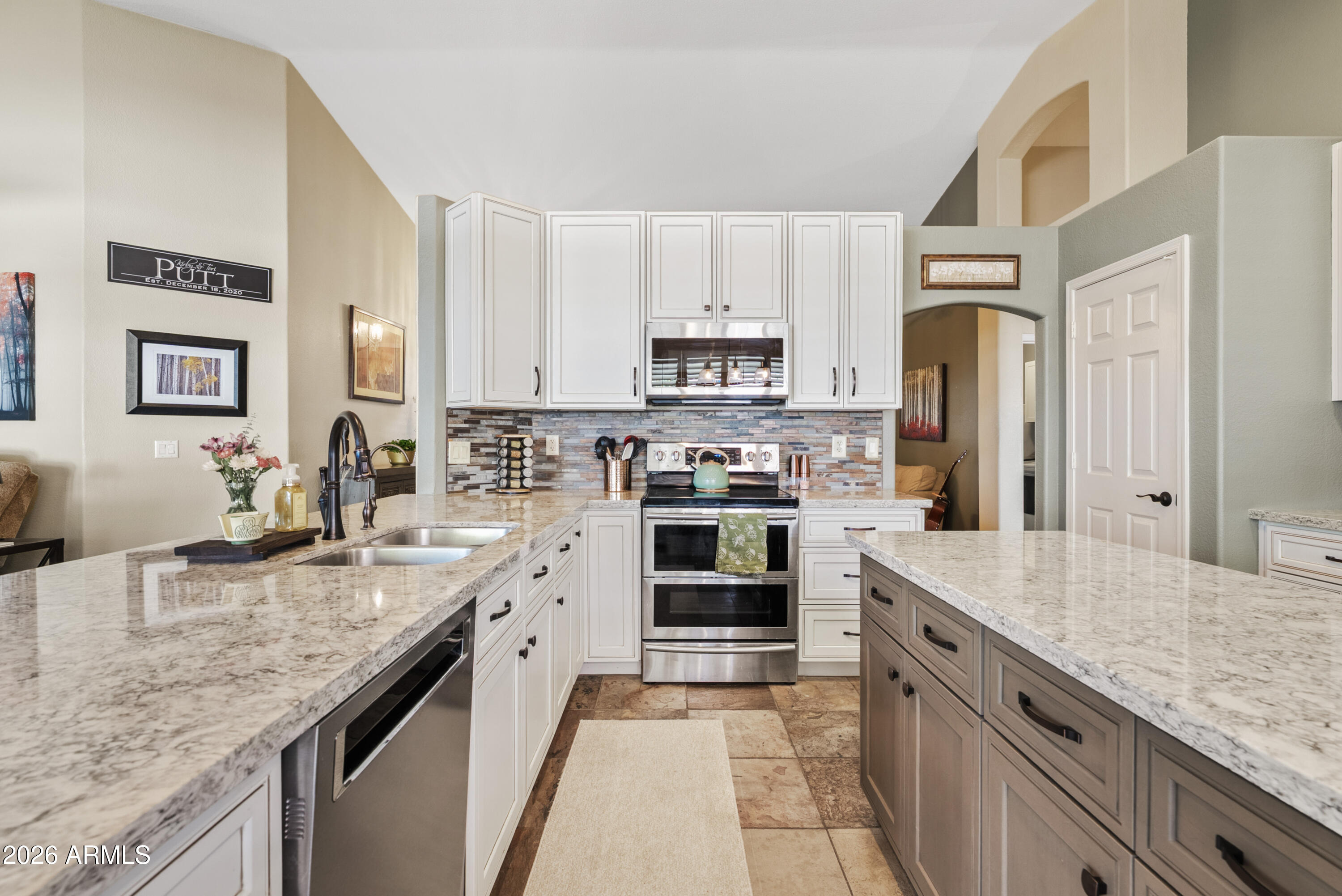 550 South Oak Street Gilbert, AZ 85233 - Photo 17 of 41 a large kitchen with granite countertop a sink counter space stainless steel appliances and cabinets